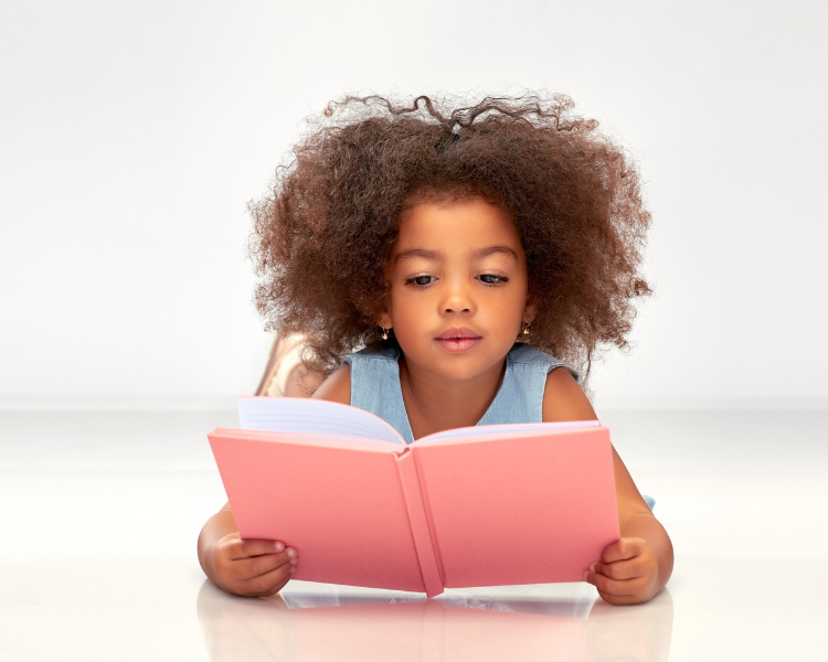 Girl reading a book with a pink cover
